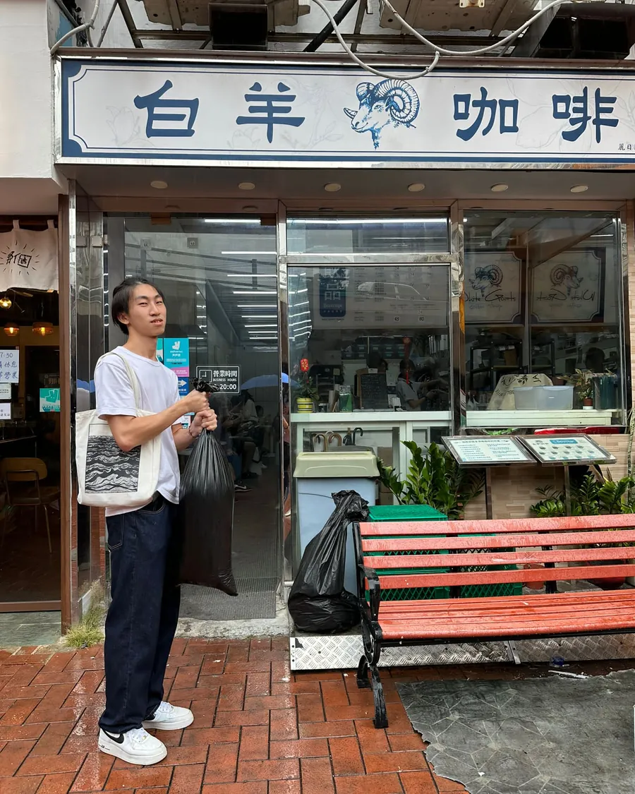 A researcher collecting grounds outside a coffee shop on Tseng Choi Street