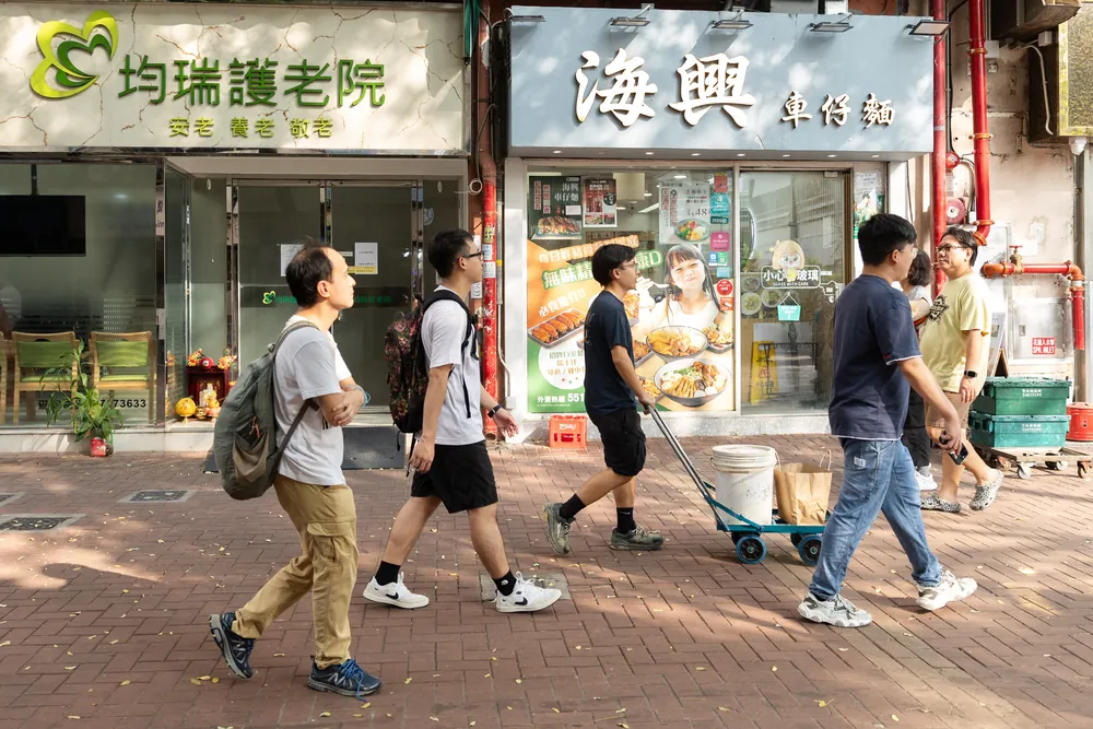 研究員推住手推車行過新墟小店